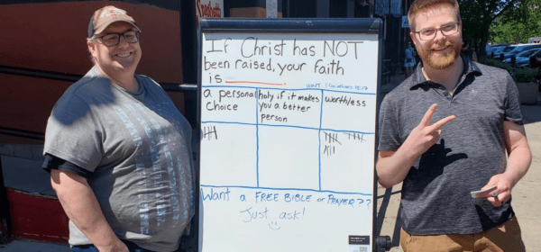 Neil and Dustin with a whiteboard doing evangelism at the Downtown Omaha Old Market