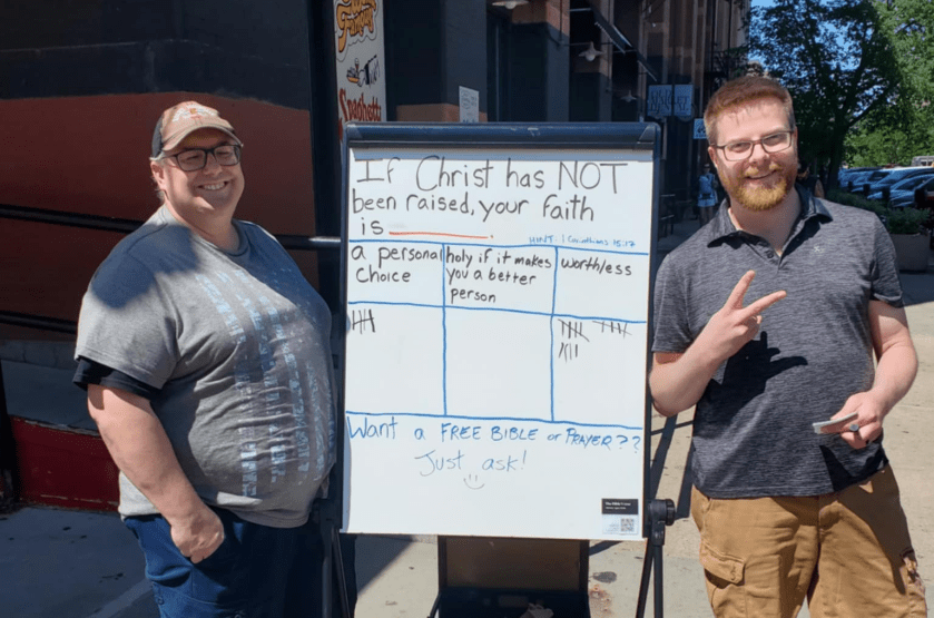 Neil and Dustin with a whiteboard doing evangelism at the Downtown Omaha Old Market